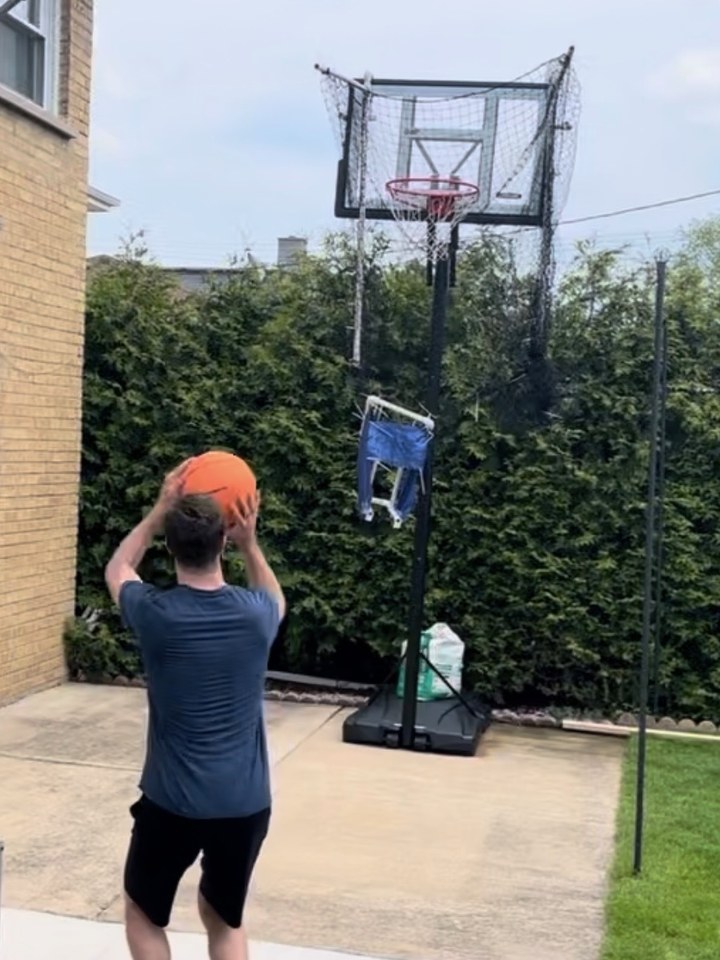 Basketball rebounder attached to a hoop, returning the ball to the shooter